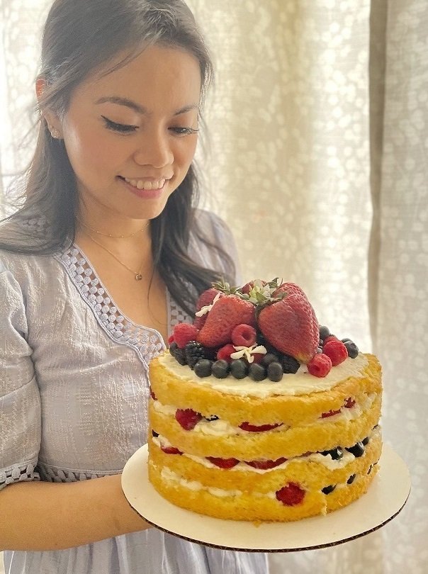 Kaye holding cake for about me